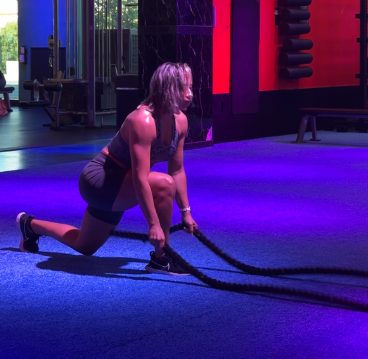 Outwork Crew client executing a powerful battle ropes exercise, enhancing core strength and endurance.